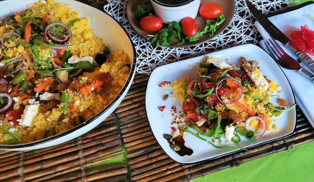 The Argilla Oval Salad Bowl and a Steak Plate filled with Polenta Salad.