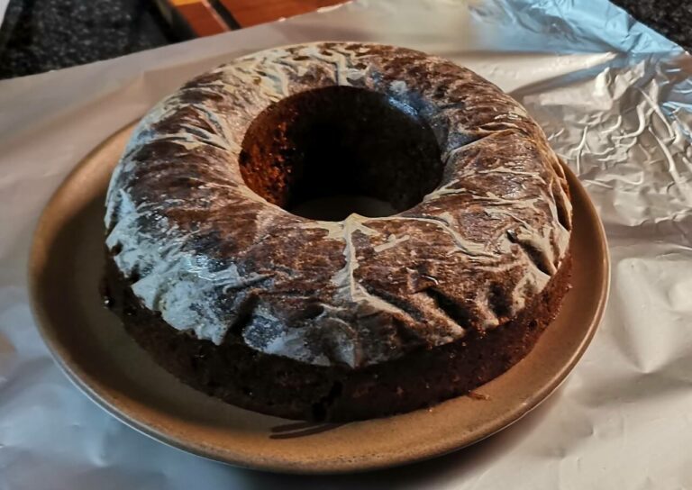 Demoulded fruit cake with baking paper.