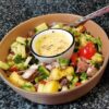 Tapas Bowl Sandstorm Tapas Bowl with a light summer salad and some dip in a Soufflé Dish in the middle of the bowl